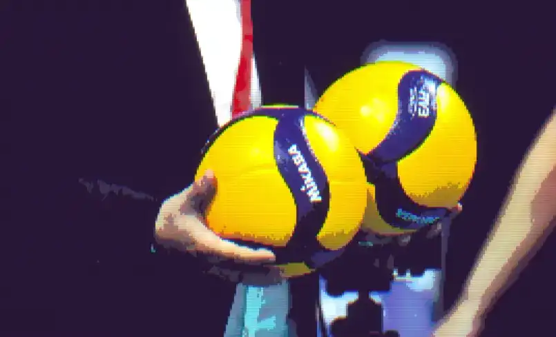 Someone holding two volleyball balls